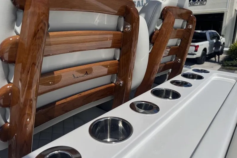 Slide: The Image of Luxurious seating and helm of 2025 Jupiter 380 LS boat, featuring modern design and controls. - 6