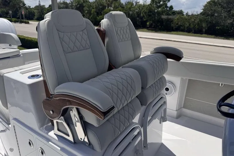 Slide: The Image of Luxury seating and cup holders on 2025 Jupiter 380 LS boat, showcasing elegant wood finish. - 7