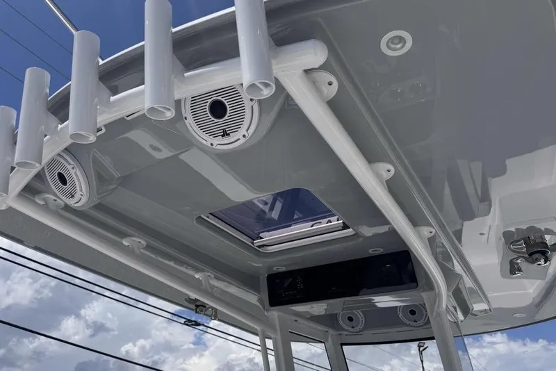 Slide: The Image of 2025 Jupiter 380 LS boat helm with dual screens, steering wheel, and controls. - 9