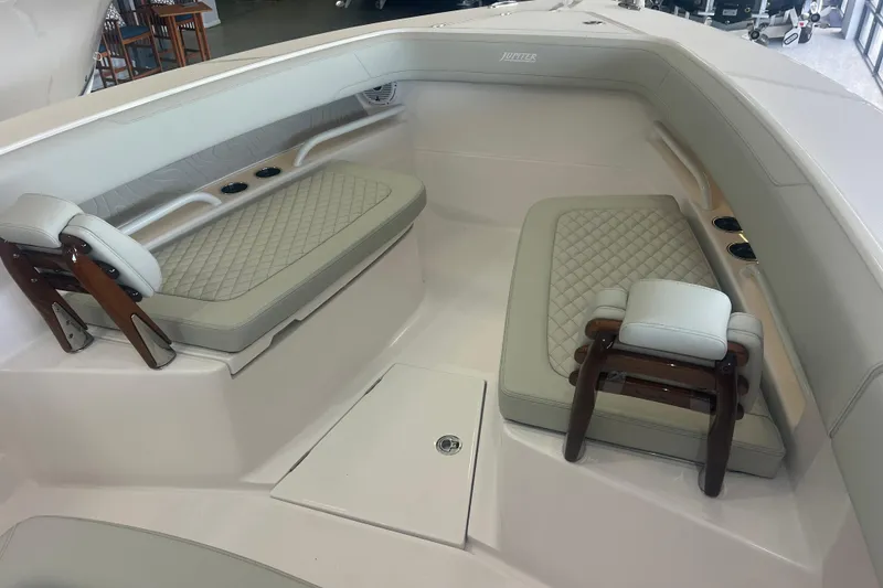 Slide: The Image of Luxurious seating area on a 2026 Jupiter 30 boat with quilted cushions and wooden accents. - 3
