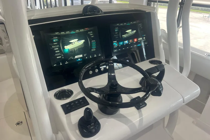 Slide: The Image of 2026 Jupiter 30 boat dashboard with dual touchscreen displays and steering wheel. - 4