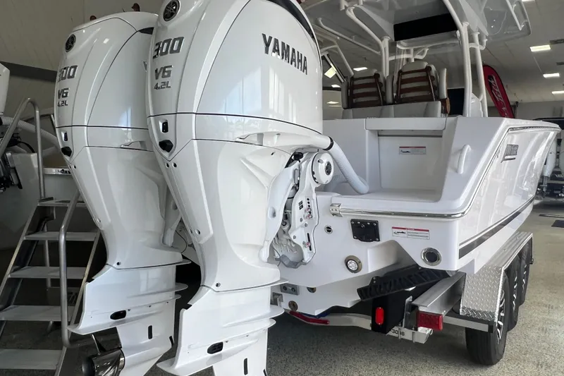 Slide: The Image of 2026 Jupiter 30 boat with dual Yamaha 300 V6 outboard engines in showroom. - 6