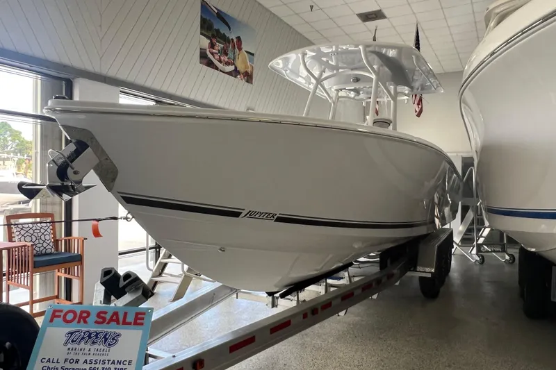 Slide: The Image of 2026 Jupiter 30 boat for sale in showroom, displayed on a trailer. - 8