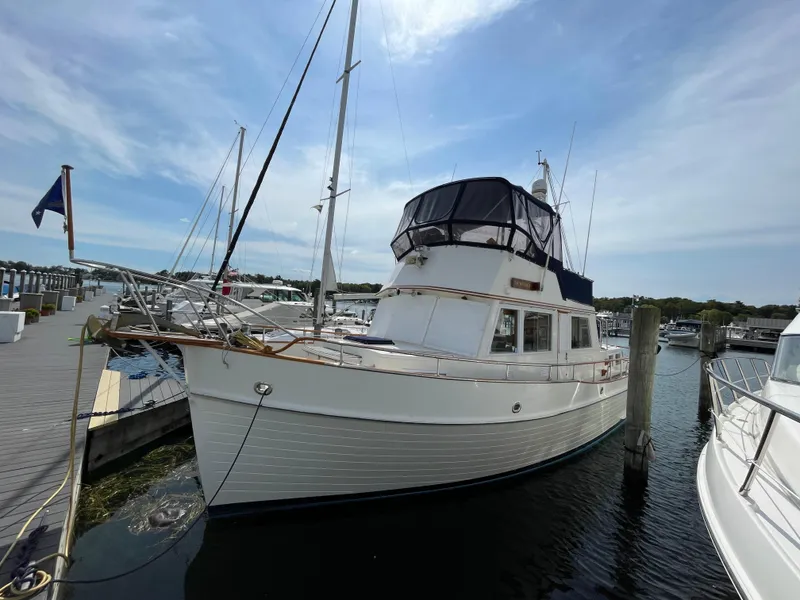 Slide: The Image of 1990 Grand Banks 42 Classic yacht docked at marina under clear sky. - 10