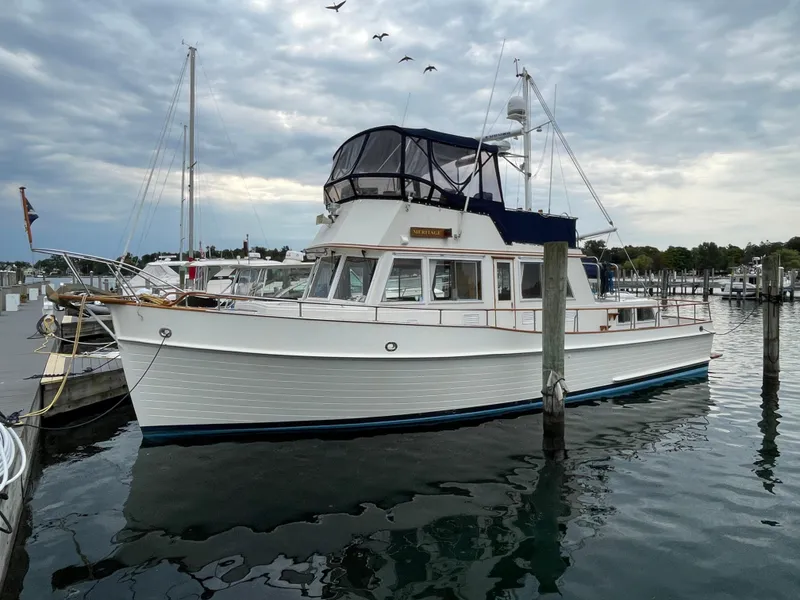 Slide: The Image of 1990 Grand Banks 42 Classic yacht docked at marina under cloudy sky. - 13