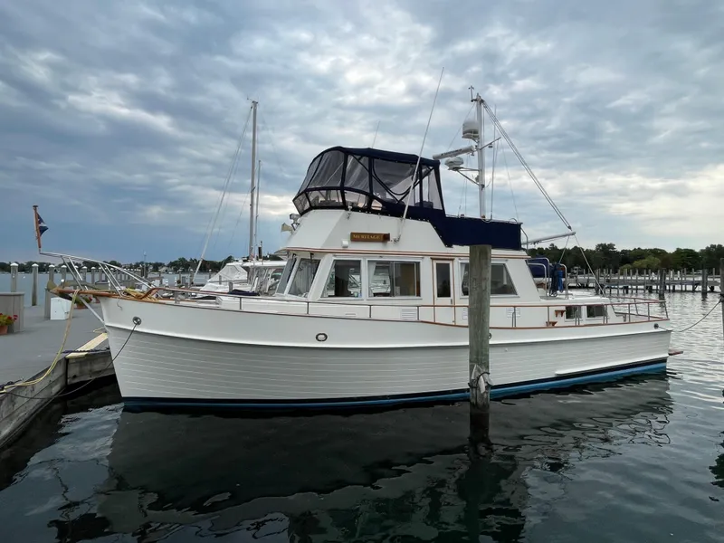 Slide: The Image of 1990 Grand Banks 42 Classic yacht docked at marina under cloudy sky. - 14