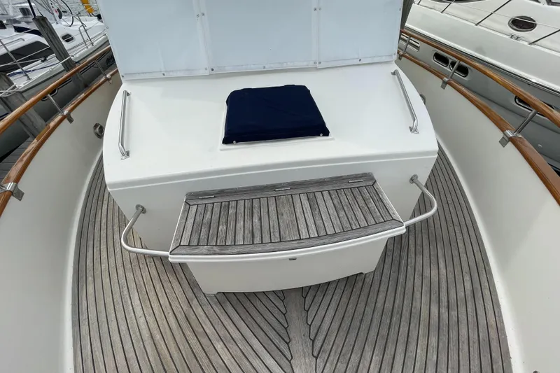 Slide: The Image of 1990 Grand Banks 42 Classic yacht deck with wooden flooring and seating area. - 21