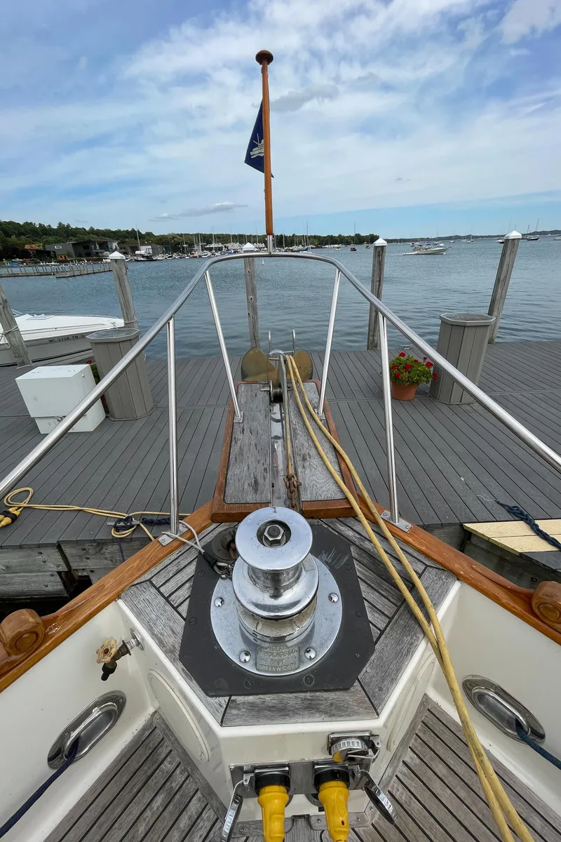 Slide: The Image of Bow view of 1990 Grand Banks 42 Classic yacht docked at a marina. - 22