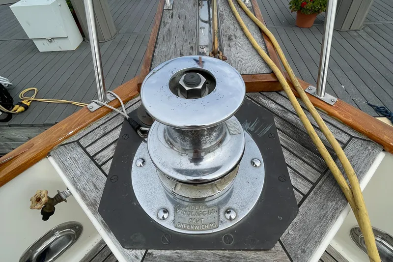 Slide: The Image of Deck of 1990 Grand Banks 42 Classic with a polished winch and wooden details. - 23