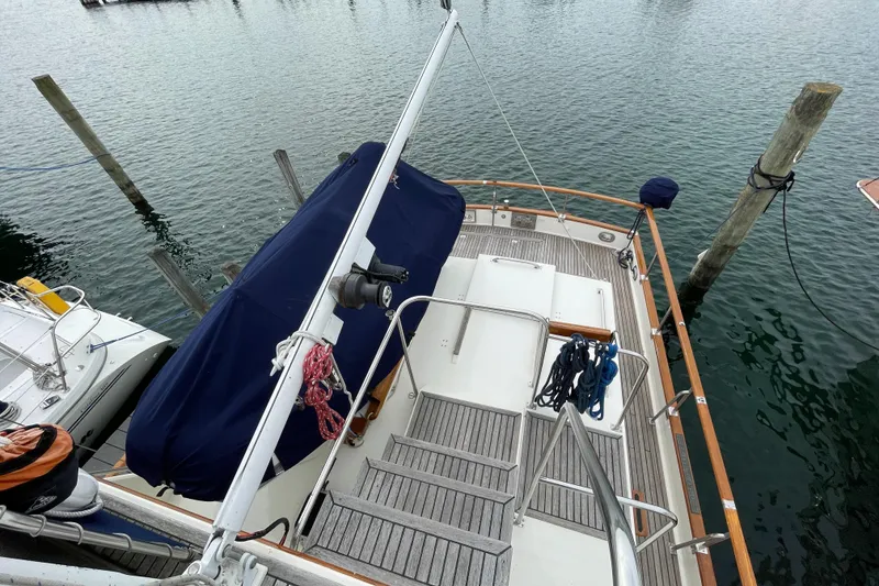 Slide: The Image of Grand Banks 42 Classic yacht deck, 1990 model, docked at marina with wooden railings. - 25