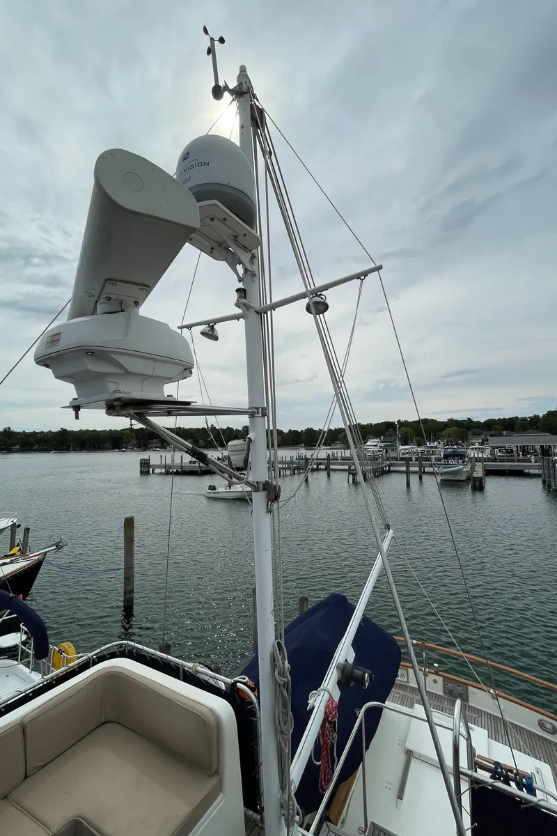 Slide: The Image of Radar equipment on a 1990 Grand Banks 42 Classic yacht, docked at a marina. - 26