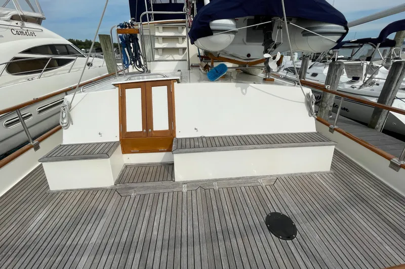 Slide: The Image of Grand Banks 42 Classic 1990 yacht deck with wooden flooring and seating area. - 28