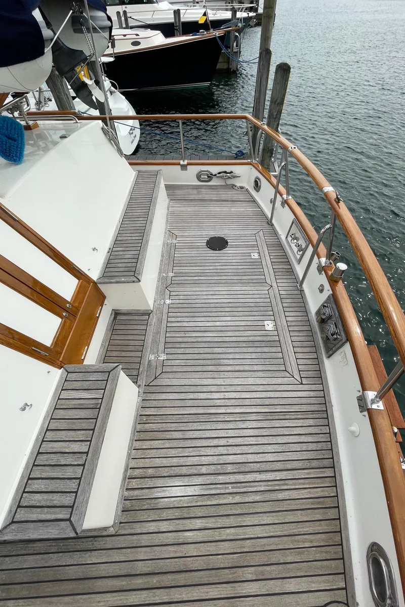Slide: The Image of Teak deck of 1990 Grand Banks 42 Classic yacht, docked at marina. - 33