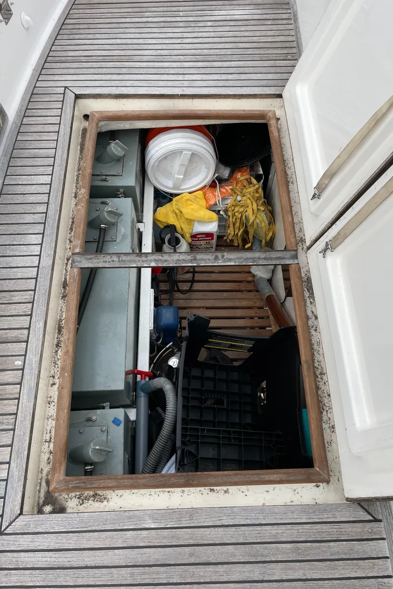 Slide: The Image of Open hatch on 1990 Grand Banks 42 Classic, revealing storage and equipment. - 35