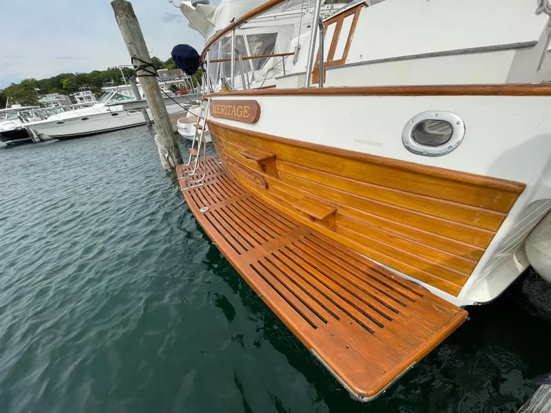 Slide: The Image of 1990 Grand Banks 42 Classic yacht with wooden deck, docked at marina. - 37