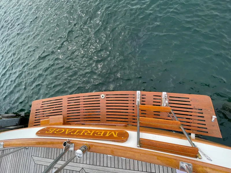 Slide: The Image of Grand Banks 42 Classic yacht stern view, wooden deck, ladder, and water reflection, 1990 model. - 38