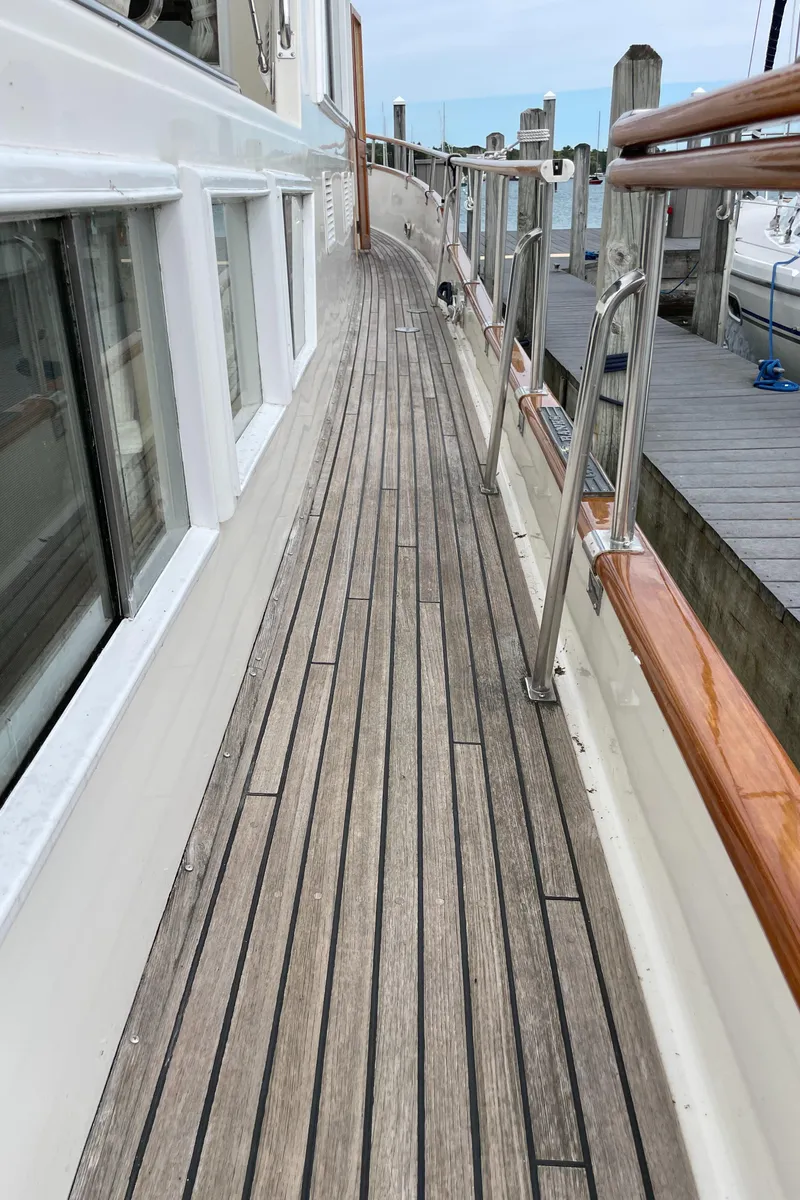 Slide: The Image of Side deck of a 1990 Grand Banks 42 Classic yacht with wooden flooring. - 39
