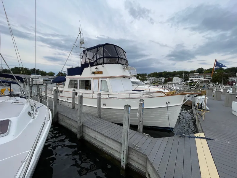 Slide: The Image of 1990 Grand Banks 42 Classic yacht docked at a marina under cloudy skies. - 4