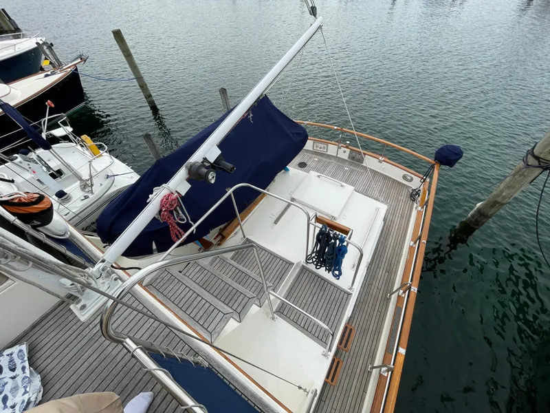 Slide: The Image of 1990 Grand Banks 42 Classic yacht docked, featuring a spacious deck and nautical equipment. - 41