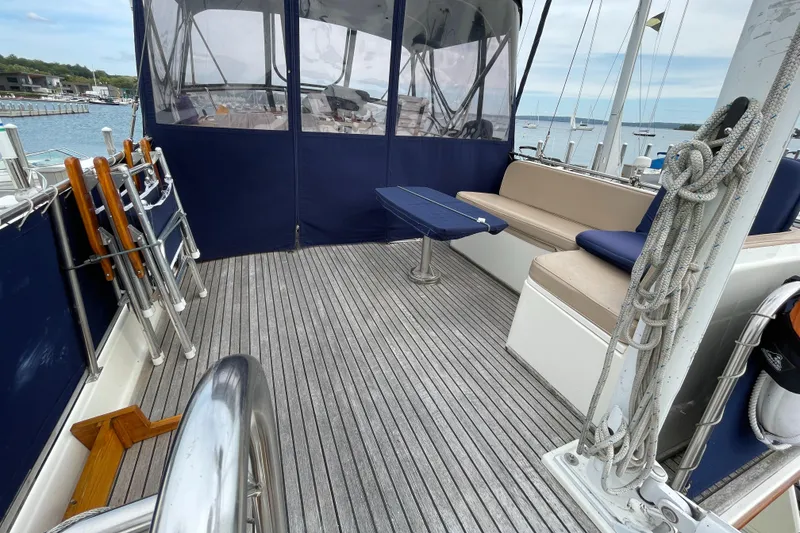 Slide: The Image of 1990 Grand Banks 42 Classic yacht deck with seating and table, overlooking marina. - 42