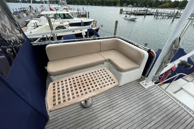 Slide: The Image of Cozy seating area on 1990 Grand Banks 42 Classic yacht, docked by the water. - 43