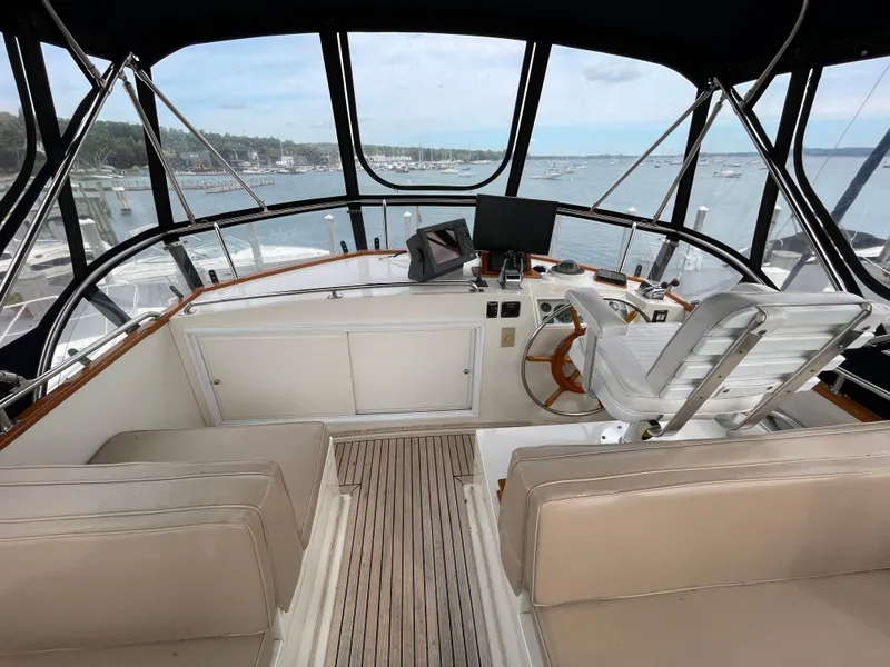 Slide: The Image of Helm of 1990 Grand Banks 42 Classic yacht with scenic marina view. - 44