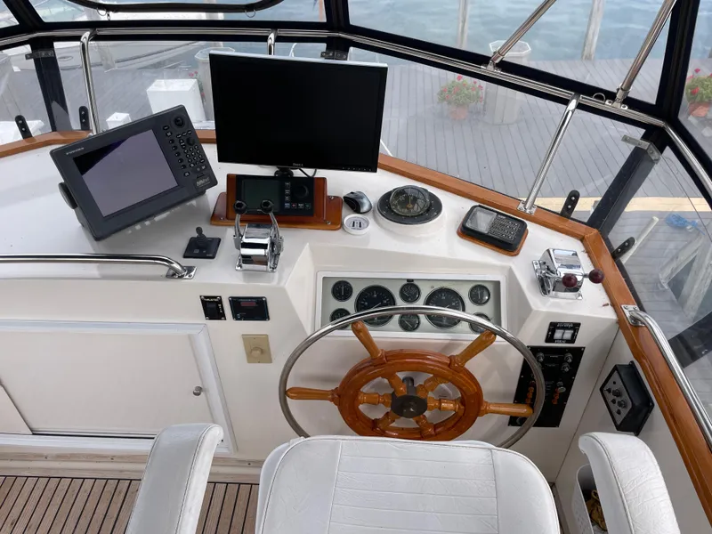 Slide: The Image of Helm of 1990 Grand Banks 42 Classic with navigation equipment and wooden steering wheel. - 48