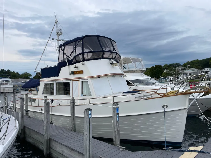 Slide: The Image of 1990 Grand Banks 42 Classic yacht docked at marina under cloudy sky. - 5