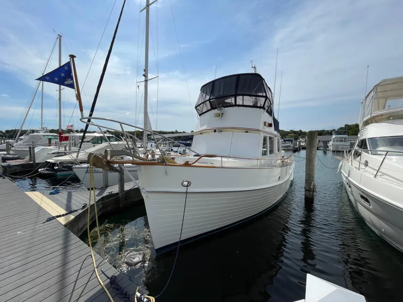 Slide: The Image of 1990 Grand Banks 42 Classic yacht docked at marina under clear sky. - 8