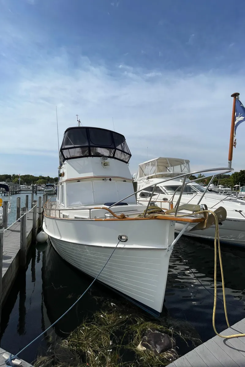 Slide: The Image of 1990 Grand Banks 42 Classic yacht docked at marina under clear sky. - 9