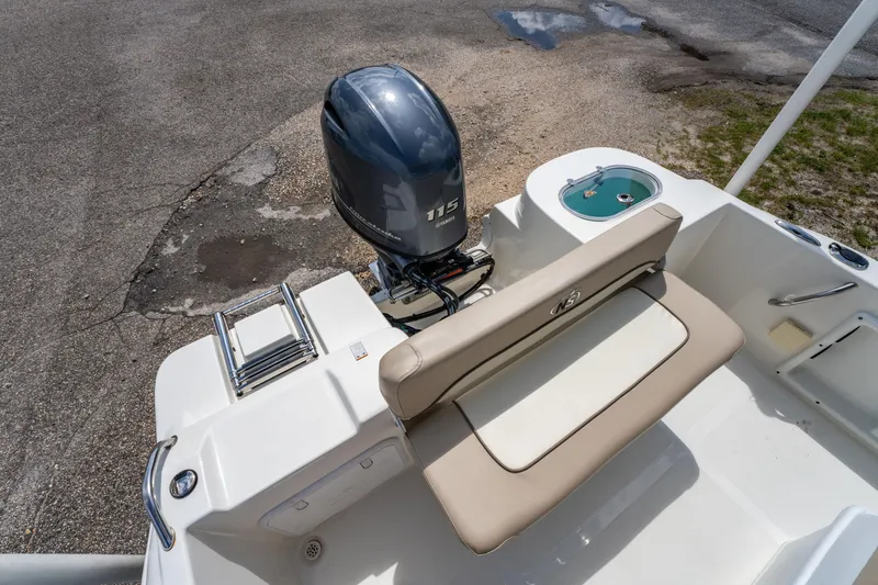 Slide: The Image of 2017 NauticStar 19XS boat with outboard motor and seating area. - 10