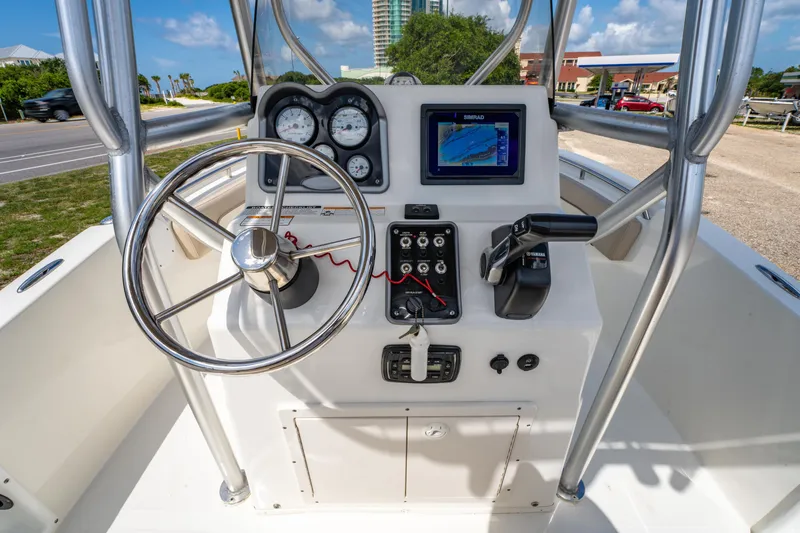 Slide: The Image of 2017 NauticStar 19XS boat console with steering wheel, gauges, and navigation system. - 14