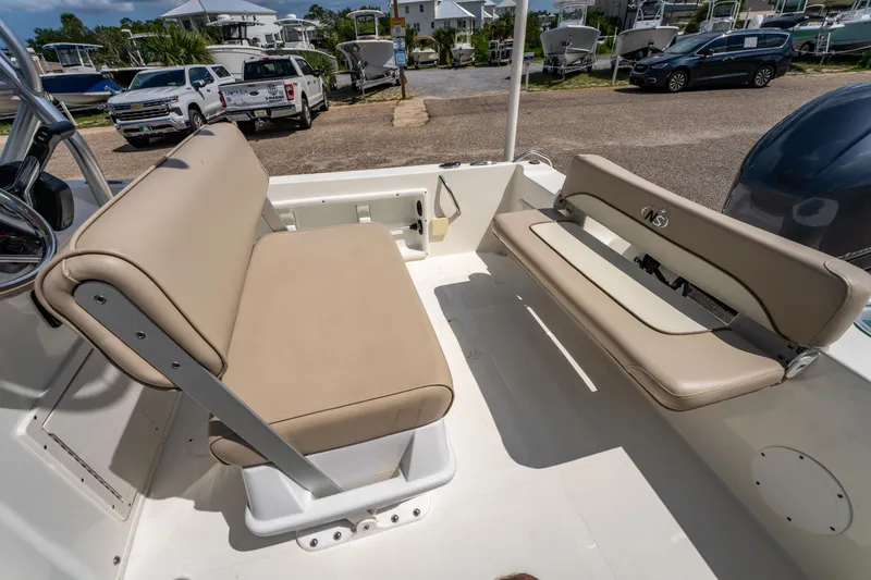 Slide: The Image of 2017 NauticStar 19XS boat interior with beige seating and steering wheel. - 20