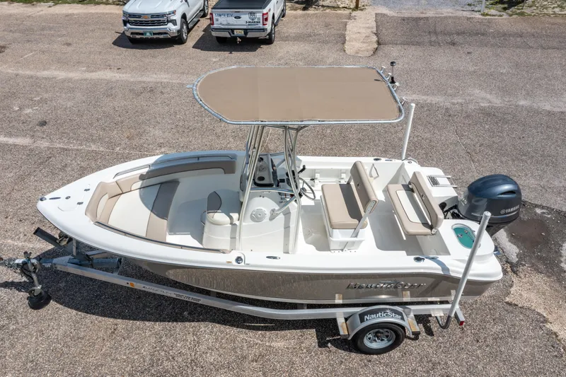 Slide: The Image of 2017 NauticStar 19XS boat on trailer, featuring Yamaha outboard motor and beige seating. - 22