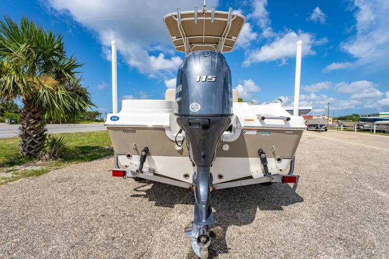 Slide: The Image of 2017 NauticStar 19XS boat with Yamaha 115 engine, parked outdoors under blue sky. - 4