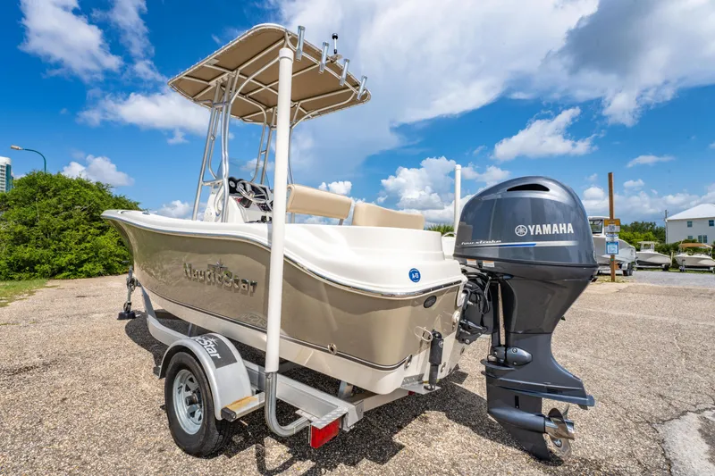 Slide: The Image of 2017 NauticStar 19XS boat with Yamaha outboard motor on trailer, parked outdoors. - 5