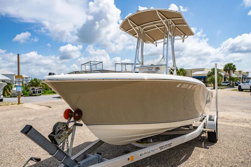 Slide: The Image of 2017 NauticStar 19XS boat on trailer under blue sky. - 7