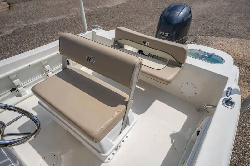 Slide: The Image of 2017 NauticStar 19XS boat interior with beige seating and Yamaha 115 outboard motor. - 8