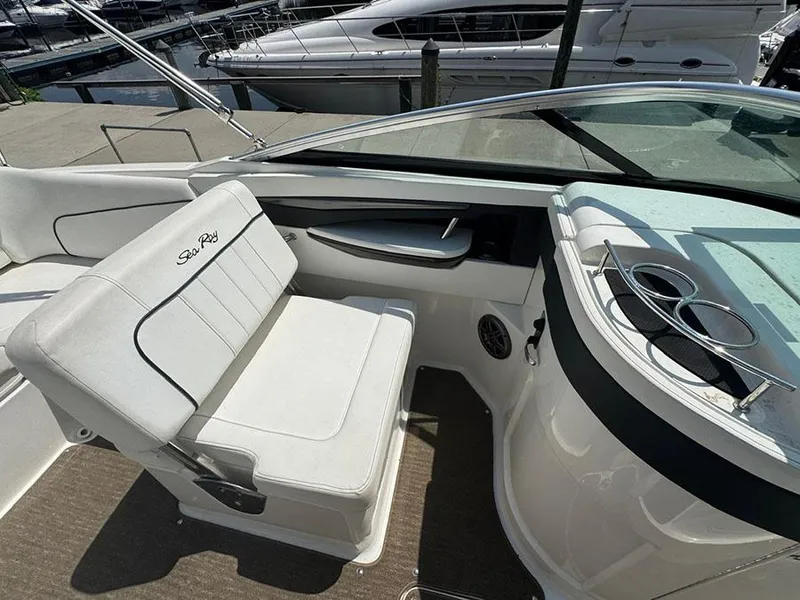 Slide: The Image of 2014 Sea Ray 240 Sundeck interior with white seating and cup holders. - 13