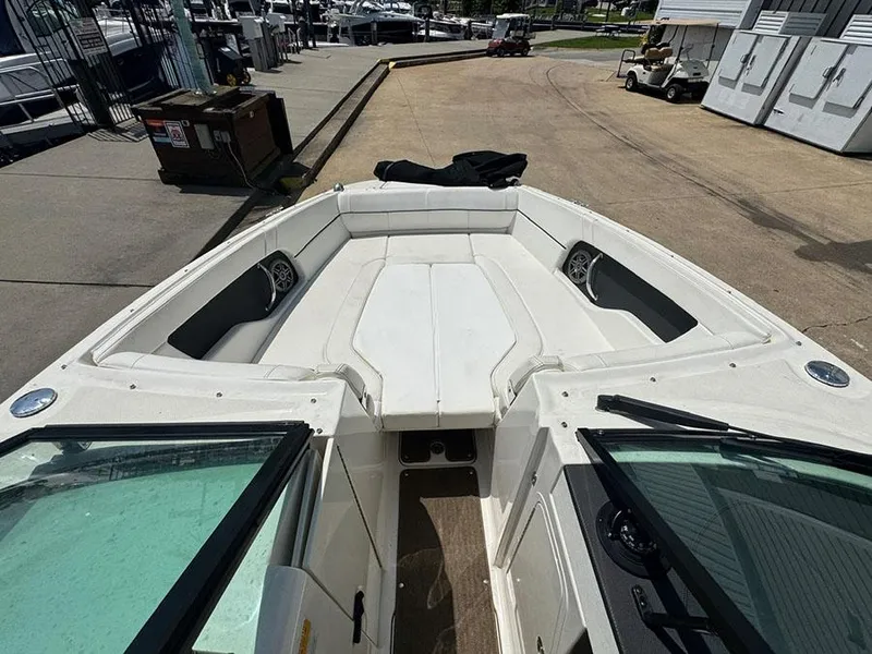 Slide: The Image of 2014 Sea Ray 240 Sundeck boat interior with white seating and speakers. - 15