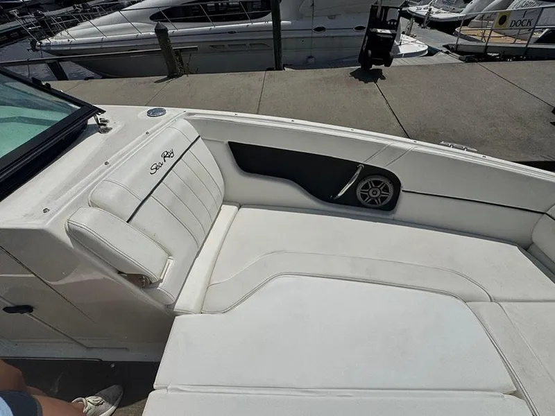 Slide: The Image of 2014 Sea Ray 240 Sundeck boat interior with white seating and speaker. - 16