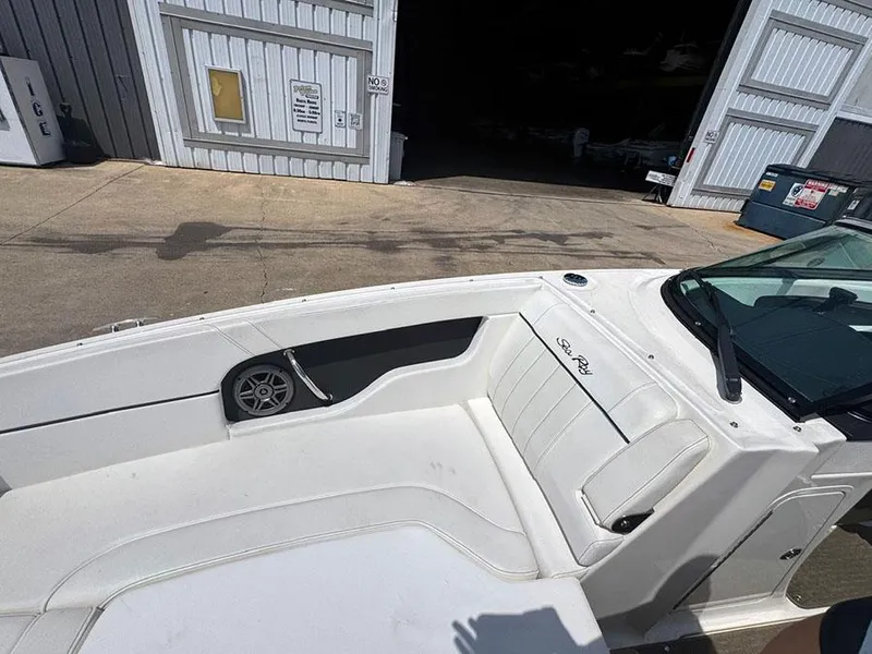 Slide: The Image of 2014 Sea Ray 240 Sundeck boat interior with white seating and speaker. - 17