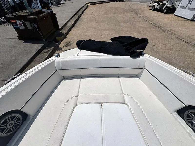 Slide: The Image of 2014 Sea Ray 240 Sundeck boat interior with white seating and speakers. - 18