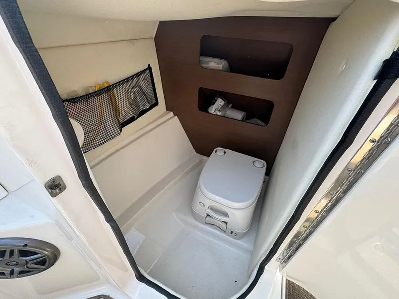 Slide: The Image of Interior of 2014 Sea Ray 240 Sundeck boat with compact toilet and storage. - 19
