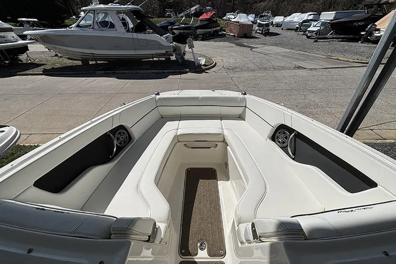 Slide: The Image of 2014 Sea Ray 240 Sundeck boat interior with white seating and speakers. - 20