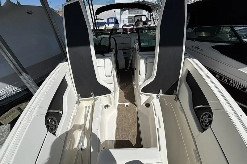 Slide: The Image of 2014 Sea Ray 240 Sundeck interior with seating and storage compartments. - 22