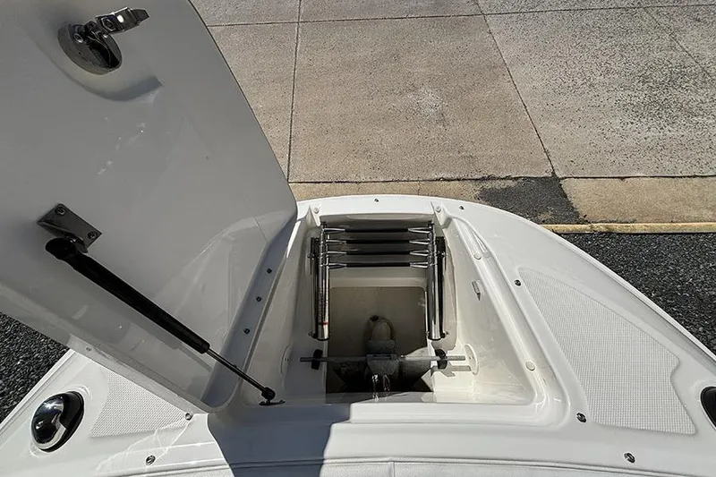 Slide: The Image of Open hatch on 2014 Sea Ray 240 Sundeck boat, revealing storage compartment. - 24