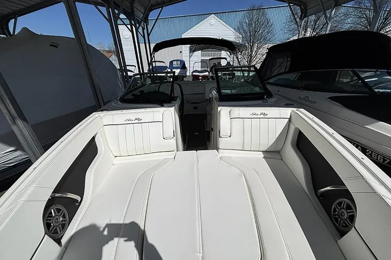 Slide: The Image of 2014 Sea Ray 240 Sundeck boat interior with white seating under a canopy. - 26