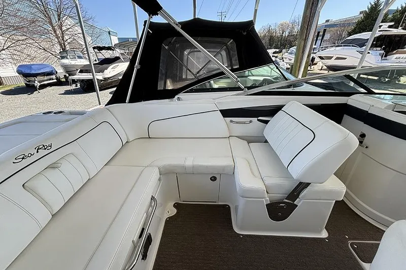 Slide: The Image of Interior of a 2014 Sea Ray 240 Sundeck boat with white seating. - 28