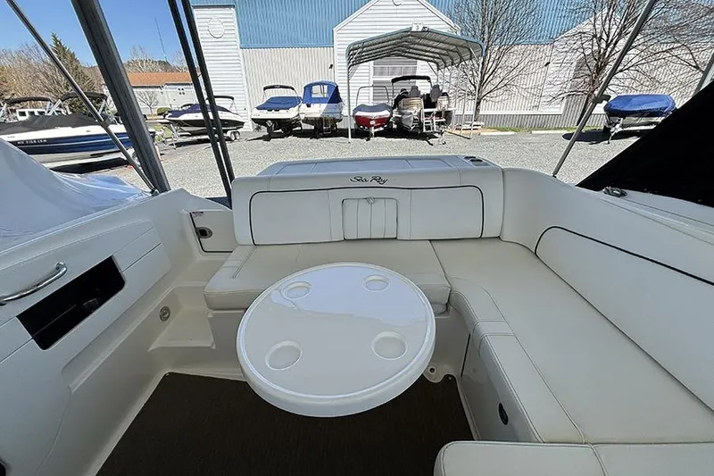 Slide: The Image of 2014 Sea Ray 240 Sundeck interior with seating and table, surrounded by other boats. - 29